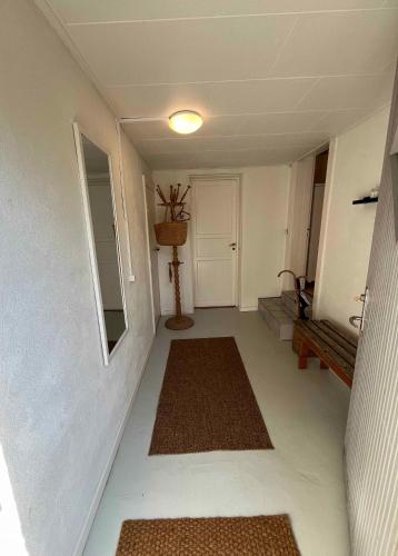 a hallway with two rugs on the floor of a house at Charming House With Beautiful Views in Gedser