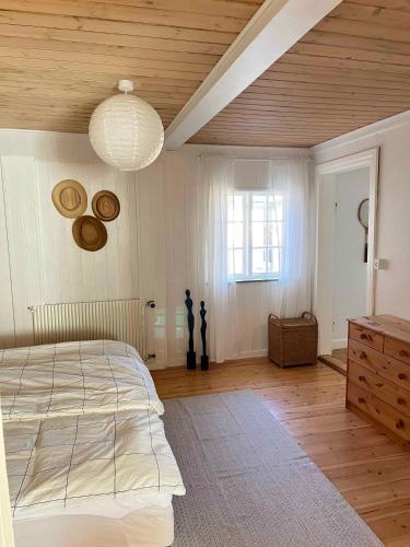 a bedroom with a large bed and a wooden ceiling at Charming House With Beautiful Views in Gedser