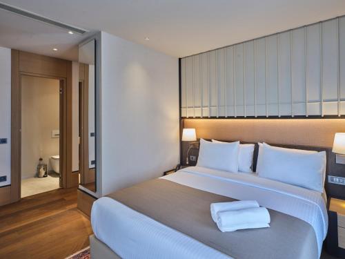 a bedroom with a large bed with two towels on it at Four-G Hotel Premium in Istanbul