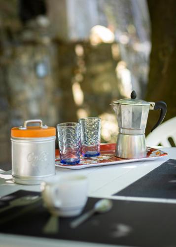 a tray with two glasses and a coffee pot on a table at U Ciousu by Ligurian Life APPARTAMENTI IN AGRITURISMO in Vallebona