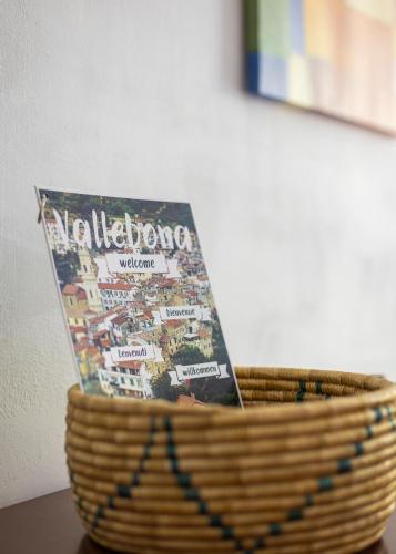 a book in a basket on a table at U Ciousu by Ligurian Life APPARTAMENTI IN AGRITURISMO in Vallebona