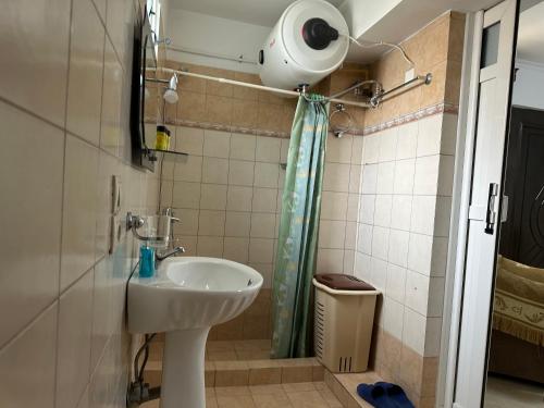 a bathroom with a sink and a toilet at Pandora Apartament in Sarandë