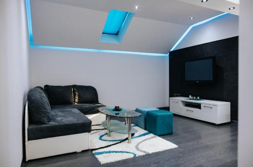 a living room with a couch and a tv at Apartment Drincic II in Brčko