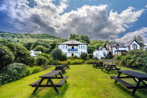 a group of picnic tables in front of a building at Lochranza Country Inn in Lochranza