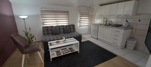 a living room with a couch and a kitchen at Apartments Platz in Mostar