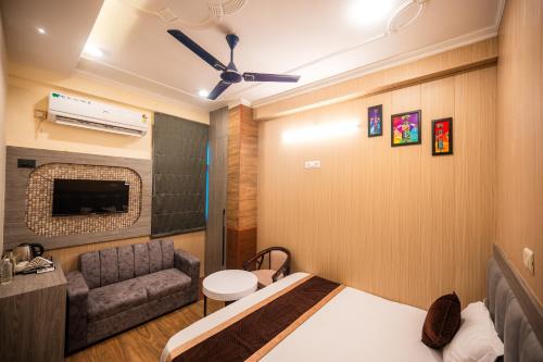 a bedroom with a bed and a couch in a room at Cozy Home Stay in Varanasi