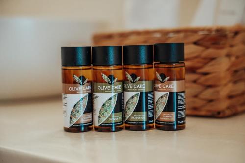 four bottles of spices sitting on a table at Rea Boutique Hotel in Himare