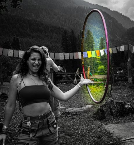 a woman holding a hula hoop in a field at The RAHIL's Kalga in Kalgha