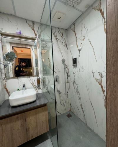 a bathroom with a sink and a mirror at Sun twilight studio in Greater Noida