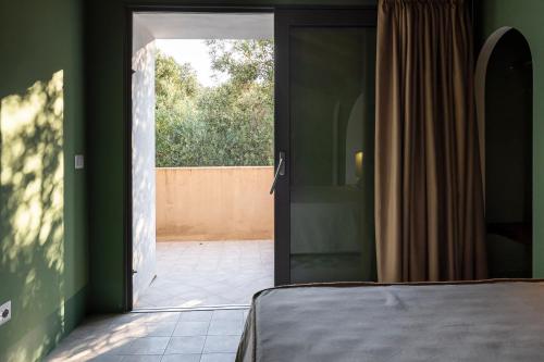 a bedroom with a door open to a patio at San Filadelfo 