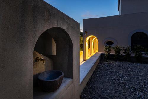 a bathroom with a tub in a stone wall at San Filadelfo 