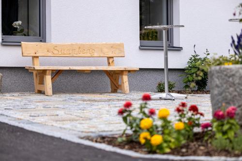 a wooden bench sitting in front of a building at Gasthof Waldschenke in Bad Leonfelden