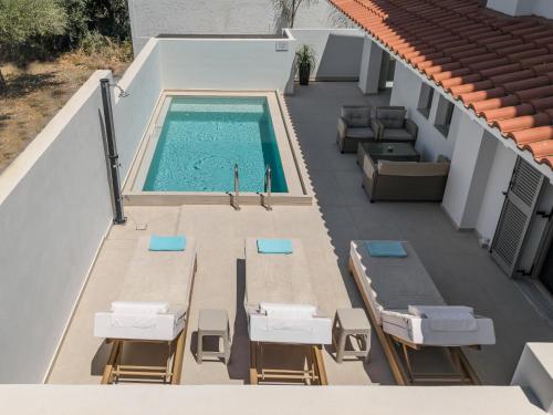 an overhead view of a swimming pool on a building at Arokaria Holiday Houses in Platanes