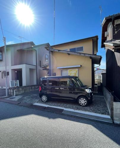 a black van parked in front of a house at Minpaku SAKURA 民泊 戸建貸切 彦根城まで車10分 無料駐車場 普通2台小型1台 in Hikone