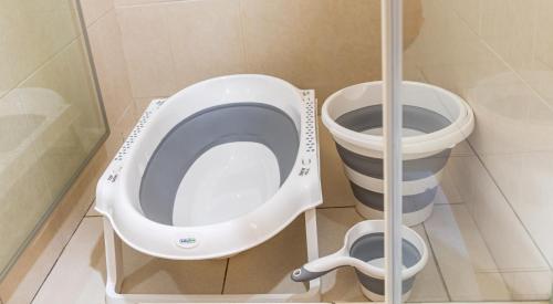 a bathroom with a toilet and a bucket at Kounous Self-Catering Apartments in La Réunion
