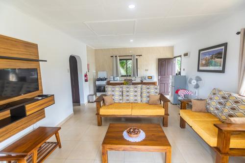 a living room with two couches and a table at Kounous Self-Catering Apartments in La Réunion