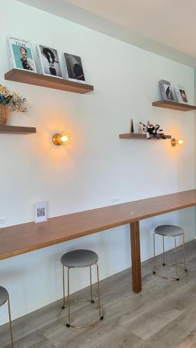 a counter in a room with two stools at アオイカゼ in Awaji