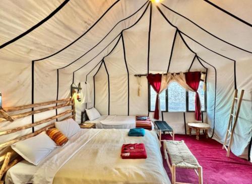 a bedroom with a bed in a tent at Staying Desert Luxury Camp in Merzouga