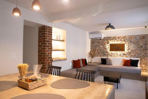 a living room with a bed and a table with chairs at Elysion stay #1 in Litochoro
