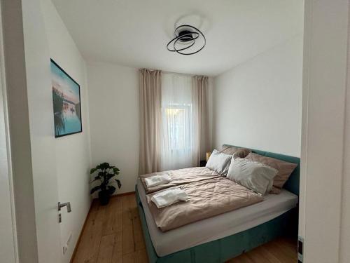 a small bedroom with a bed in a room at Nexus apartman in Siófok