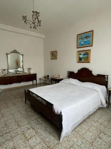 a bedroom with a large bed and a mirror at Home Green in Mògoro