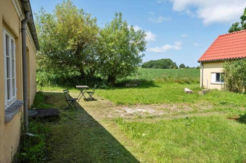 a yard with a table and chairs next to a building at 4037-Borre-Sondre-Landevej-37 in Borre
