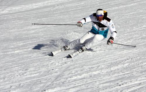 a man is skiing down a snow covered slope at Shackleton Chalet in Sestriere