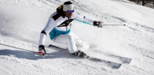 a man is skiing down a snow covered slope at Shackleton Chalet in Sestriere