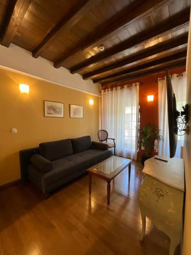 a living room with a couch and a coffee table at Archontiko Leontari in Leondari