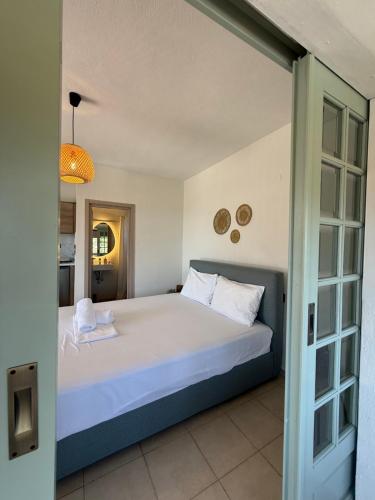 a bedroom with a large bed in a room at BLOOM Studios in Achillion Magnisia