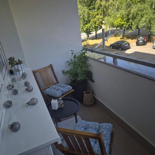 a balcony with two chairs and a table and a window at Apartman Rita in Livno