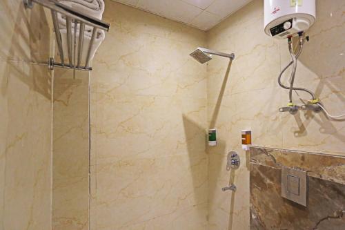 a shower with a glass door in a bathroom at Hotel Iconic Suite - Near Delhi Airport in New Delhi