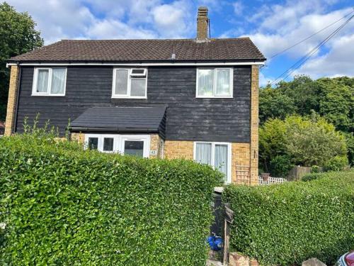a house with a hedge in front of a house at Garden house in Canterbury
