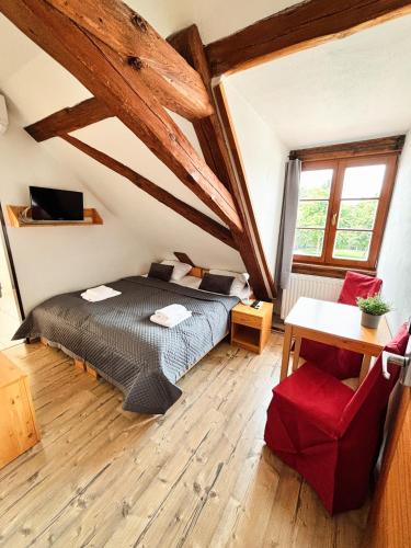 a bedroom with a bed in a room with wooden ceilings at Wellness hotel & minipivovar Kněžínek in České Budějovice