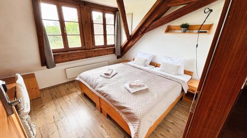 a bedroom with a bed and a window at Wellness hotel & minipivovar Kněžínek in České Budějovice