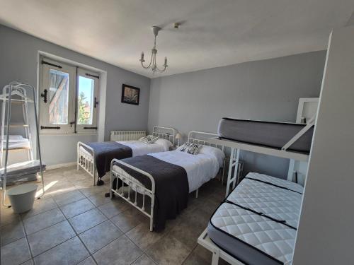 a hospital room with three beds and a window at Casa Rural Las Bengoas in Alesanco