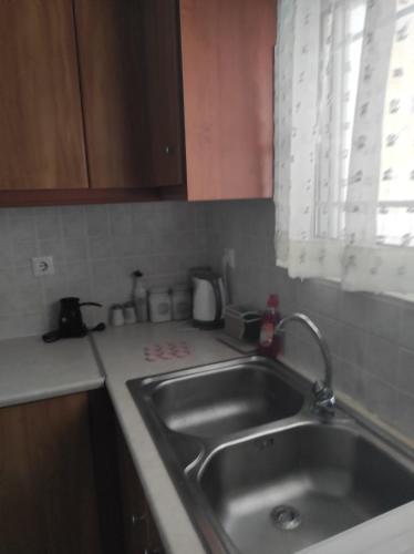 a kitchen with a sink and a counter top at Tasos Art in Káto Almirí