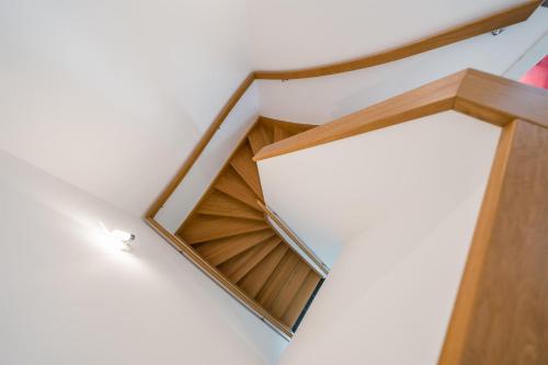 a spiral staircase in a house with a wooden door at Residence Salzgeber in Schruns-Tschagguns