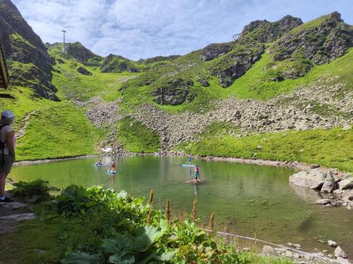 a group of people in a river in the mountains at Residence Salzgeber in Schruns-Tschagguns