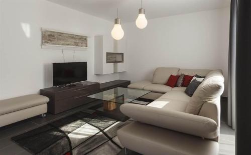 a living room with a couch and a table at Residence Salzgeber in Schruns-Tschagguns