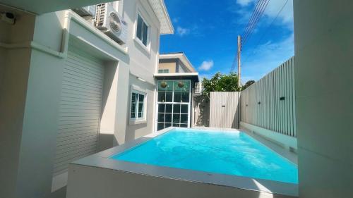 a swimming pool in the backyard of a house at Private Pool Getaway - Baan Hug Ubon Warinchamrap in Ubon Ratchathani