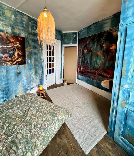 a room with a bed and a painting on the wall at Chambre chez l habitant in Saint-Hilaire-du-Harcouët