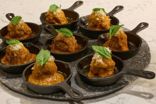 a tray of food in little dishes with leaves on them at The Woodlands Waterway Marriott Hotel and Convention Center in The Woodlands