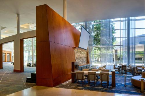 a lobby with a table and chairs in a building at The Woodlands Waterway Marriott Hotel and Convention Center in The Woodlands
