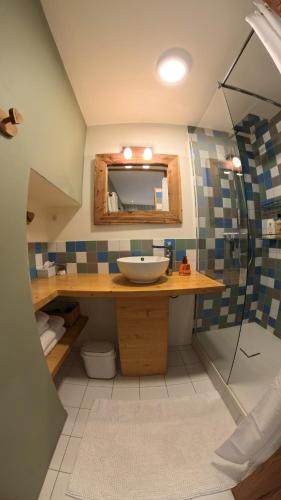 a bathroom with a sink and a shower at Papillon 05 - Wellness in Briançon