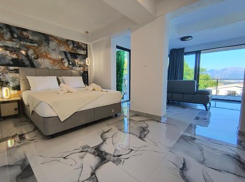 a bedroom with a bed with a marble floor at Villa vista mare in Zagrađe