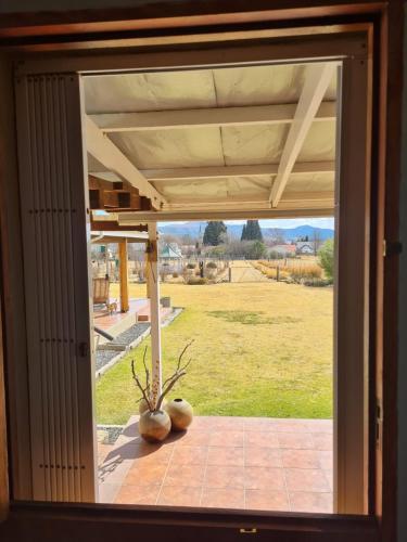 a window with a view of a field of grass at Meadow View Retro Accommodation in Wakkerstroom