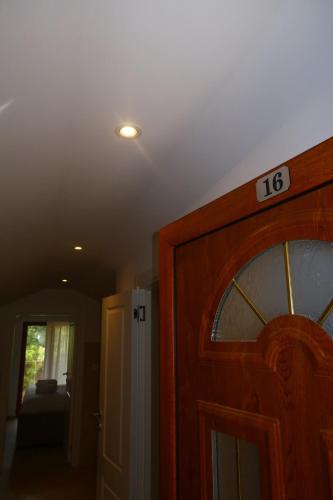 a room with a door with a clock on it at Apartmani Milos - Meljine in Herceg-Novi