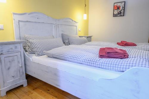 two beds in a bedroom with a white bed frame at Ferienhaus Ottenhöfen - Sauna | Hot Tub in Ottenhöfen