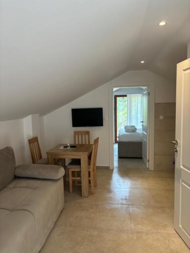 a living room with a couch and a table at Apartmani Milos - Meljine in Herceg-Novi